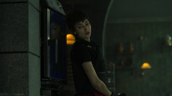 Movie still from “Money Heist” (2017), created by Álex Pina – A woman standing in front of a vending machine; Close Up shot, Low angle