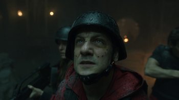 Movie still from “Money Heist” (2017), created by Álex Pina – A man wearing a helmet and a red jacket; Close Up shot, Low angle