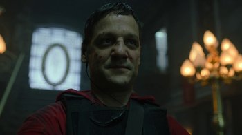 Movie still from “Money Heist” (2017), created by Álex Pina – A person wearing a red shirt; Close Up shot, Low angle