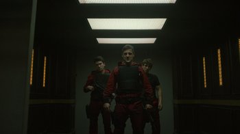 Movie still from “Money Heist” (2017), created by Álex Pina – A group of men standing next to each other in a room; Medium shot, Low angle