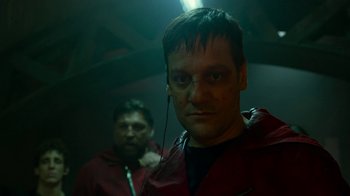 Movie still from “Money Heist” (2017), created by Álex Pina – A man in a red jacket and a man in a black jacket; Close Up shot, Low angle