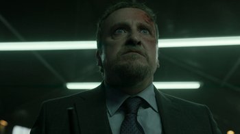 Movie still from “Money Heist” (2017), created by Álex Pina – A person wearing a suit and tie; Close Up shot, Low angle