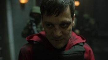 Movie still from “Money Heist” (2017), created by Álex Pina – A person wearing a red jacket; Close Up shot, Low angle