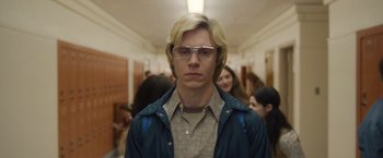 Movie still from “Monster” (2022), directed by Clement Virgo – A man with blonde hair and glasses in a hallway; Close Up shot, Low angle