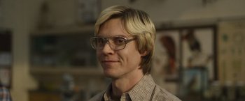 Movie still from “Monster” (2022), directed by Clement Virgo – A person wearing glasses and a plaid shirt; Close Up shot, Low angle