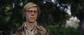 Movie still from “Monster” (2022), directed by Clement Virgo – A young man with blonde hair wearing glasses and a plaid shirt; Close Up shot, Low angle
