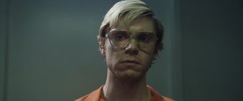 Movie still from “Monster” (2022), directed by Clement Virgo – A person wearing glasses; Close Up shot, Low angle