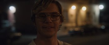 Movie still from “Monster” (2022), directed by Clement Virgo – A young man wearing glasses looking at the camera; Close Up shot, Over the shoulder angle