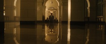 Movie still from “Monster” (2022), directed by Clement Virgo – A group of people sitting in a room with lights; Extreme Wide shot, Low angle