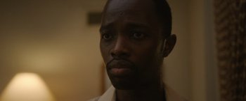 Movie still from “Monster” (2022), directed by Clement Virgo – A man's face in a room; Close Up shot, Low angle