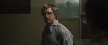 Movie still from “Monster” (2022), directed by Clement Virgo – A man with glasses is standing in front of a window; Close Up shot, Over the shoulder angle