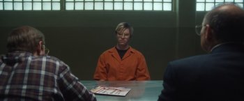 Movie still from “Monster” (2022), directed by Clement Virgo – A man sitting at a table in an interrogation room; Medium shot, Over the shoulder angle