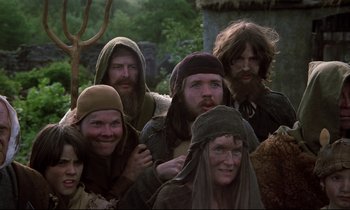 Movie still from “Monty Python and the Holy Grail” (1975), directed by Terry Gilliam – A group of people standing next to each other; Medium shot, Low angle