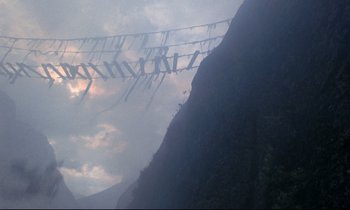 Movie still from “Monty Python and the Holy Grail” (1975), directed by Terry Gilliam – A view of a mountain with a sky background; Extreme Wide shot, Low angle