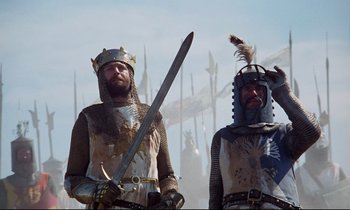 Movie still from “Monty Python and the Holy Grail” (1975), directed by Terry Gilliam – Two men dressed in medieval costumes holding swords; Medium shot, Low angle