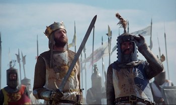 Movie still from “Monty Python and the Holy Grail” (1975), directed by Terry Gilliam – Two men dressed in medieval clothing holding swords; Medium shot, Low angle