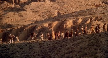 Movie still from “Life of Brian” (1979), directed by Terry Jones – A group of people standing on top of a hill; Extreme Wide shot, High angle