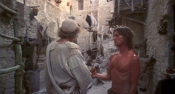 Movie still from “Life of Brian” (1979), directed by Terry Jones – Two men in medieval garb talking in an alleyway; Medium shot, Low angle