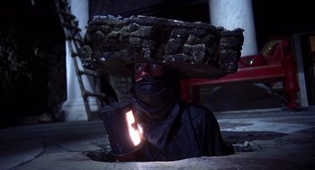 Movie still from “Life of Brian” (1979), directed by Terry Jones – A man with a brick on top of his head; Medium shot, Low angle