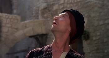 Movie still from “Life of Brian” (1979), directed by Terry Jones – A man wearing a hat looking up into the sky; Close Up shot, Low angle