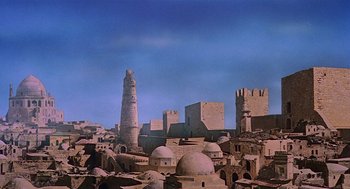 Movie still from “Life of Brian” (1979), directed by Terry Jones – An old city with many buildings and a tall tower; Extreme Wide shot, Low angle