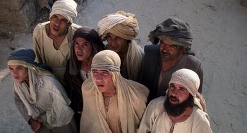 Movie still from “Life of Brian” (1979), directed by Terry Jones – A group of men wearing head scarfs standing next to each other; Medium shot, Low angle