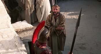 Movie still from “Life of Brian” (1979), directed by Terry Jones – A man in a costume and a helmet talking to a man in a costume; Medium shot, Over the shoulder angle
