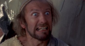 Movie still from “Life of Brian” (1979), directed by Terry Jones – A person with an angry look on their face; Close Up shot, Low angle