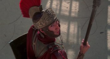 Movie still from “Life of Brian” (1979), directed by Terry Jones – A man in a roman soldier's helmet and armor; Close Up shot, Over the shoulder angle