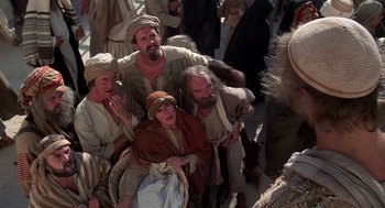 Movie still from “Life of Brian” (1979), directed by Terry Jones – A group of men and women standing next to each other; Medium shot, High angle