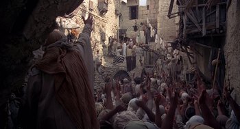 Movie still from “Life of Brian” (1979), directed by Terry Jones – A group of people gathered in a street; Extreme Wide shot, High angle