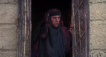 Movie still from “Life of Brian” (1979), directed by Terry Jones – A man wearing a headscarf and a black robe; Medium shot, Low angle