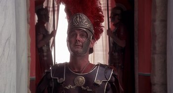 Movie still from “Life of Brian” (1979), directed by Terry Jones – A man in a roman soldier's outfit with red feathers on his head; Close Up shot, Low angle