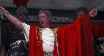 Movie still from “Life of Brian” (1979), directed by Terry Jones – A man dressed in roman clothing and holding his hands up; Medium shot, Low angle