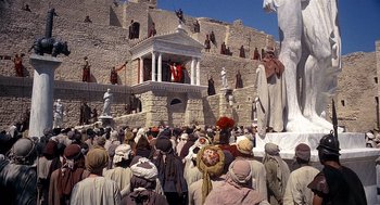 Movie still from “Life of Brian” (1979), directed by Terry Jones – A crowd of people gathered around a statue of jesus; Extreme Wide shot, Low angle