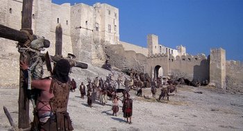 Movie still from “Life of Brian” (1979), directed by Terry Jones – A group of people standing next to each other on a beach; Extreme Wide shot, High angle