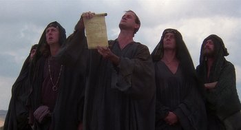 Movie still from “Life of Brian” (1979), directed by Terry Jones – A group of men in black robes holding papers; Medium shot, Low angle