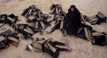 Movie still from “Life of Brian” (1979), directed by Terry Jones – A group of people dressed in medieval costumes laying on the ground; Wide shot, High angle