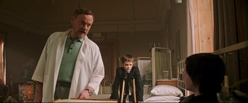 Movie still from “Morbius” (2022), directed by Daniel Espinosa – A man and a young boy in a hospital room; Medium shot, Low angle