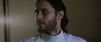 Movie still from “Morbius” (2022), directed by Daniel Espinosa – A man with long black hair and a beard; Close Up shot, Over the shoulder angle