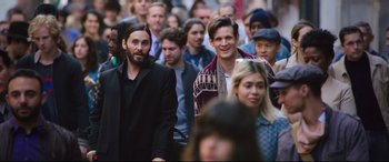 Movie still from “Morbius” (2022), directed by Daniel Espinosa – A group of people that are standing in the street; Medium shot, Over the shoulder angle