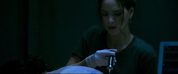 Movie still from “Morbius” (2022), directed by Daniel Espinosa – A woman in a black shirt is working on a tattoo; Close Up shot, Over the shoulder angle