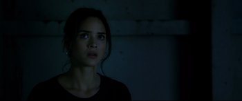 Movie still from “Morbius” (2022), directed by Daniel Espinosa – A young woman stares into the distance in the dark; Close Up shot, Low angle