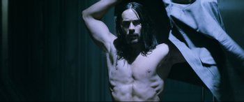 Movie still from “Morbius” (2022), directed by Daniel Espinosa – A man with long black hair is posing for the camera; Medium shot, High angle