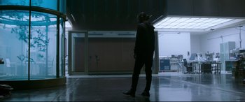 Movie still from “Morbius” (2022), directed by Daniel Espinosa – A man standing in a dark room with headphones on; Wide shot, Low angle