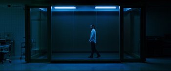 Movie still from “Morbius” (2022), directed by Daniel Espinosa – A man is walking in a dark room; Wide shot, Low angle