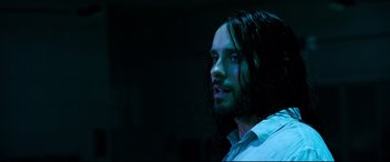Movie still from “Morbius” (2022), directed by Daniel Espinosa – A person with long black hair; Close Up shot, High angle