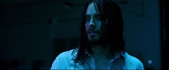 Movie still from “Morbius” (2022), directed by Daniel Espinosa – A man with long hair and a white dress shirt; Close Up shot, High angle