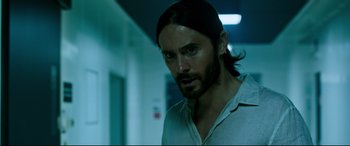 Movie still from “Morbius” (2022), directed by Daniel Espinosa – A person with long black hair; Close Up shot, Over the shoulder angle