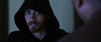 Movie still from “Morbius” (2022), directed by Daniel Espinosa – A person wearing a hooded jacket; Close Up shot, Over the shoulder angle